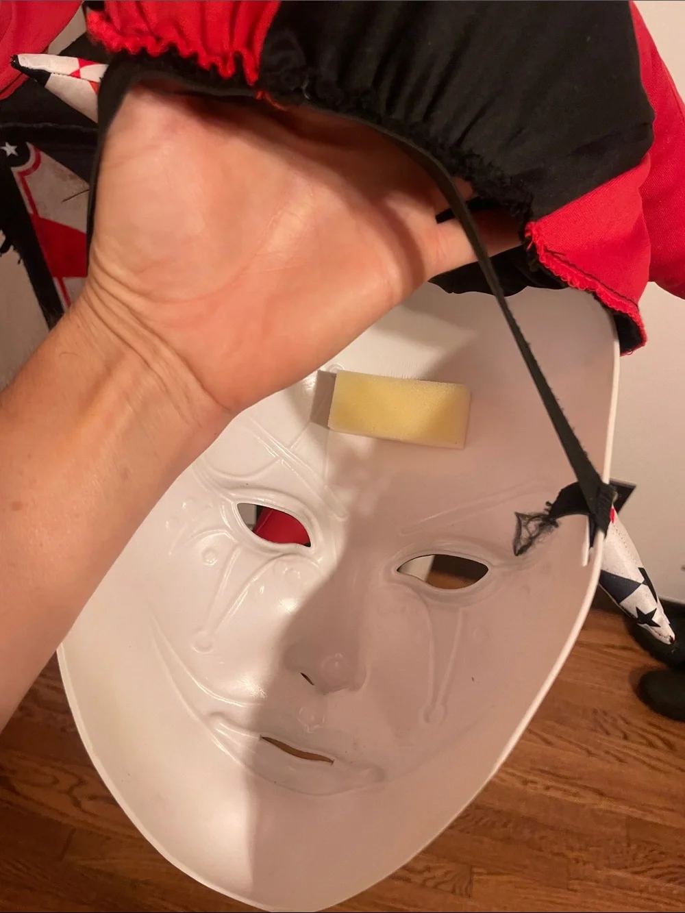 Dirty, scary Jack-in-box Halloween costume or cosplay, including jeweled mask.